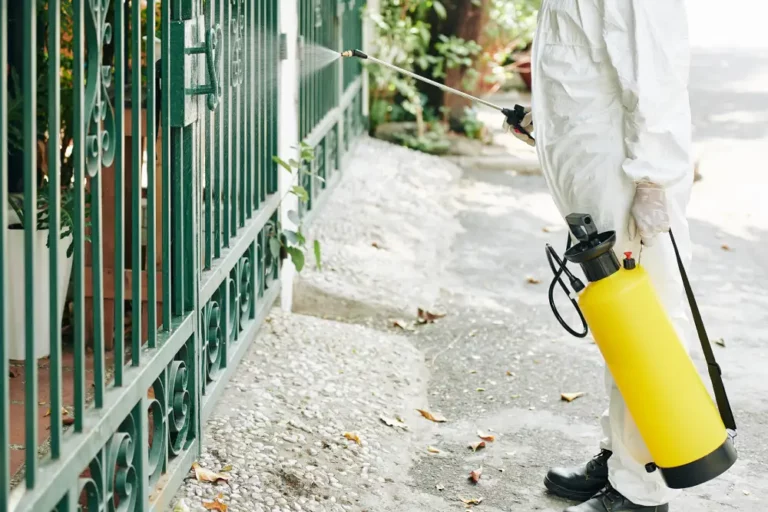 technician spraying a fence